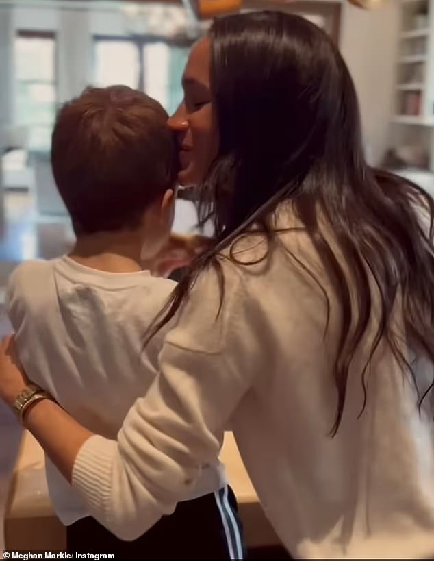 Meghan kisses Archie, six, in a video shared on her Instagram offering a rare look at the Sussexes private family life