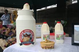 Ken's Raw Jersey Milk at a market stall.