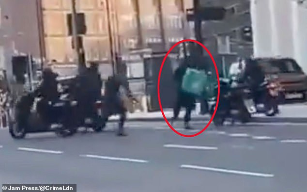 This is the shocking moment a Deliveroo rider was mobbed by a masked gang who wrestled his moped from him before using it to flee