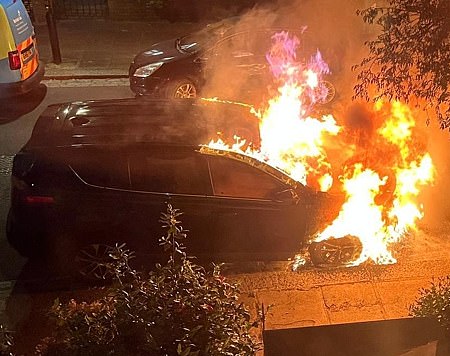 Exclusive MailOnline footage shows the dark blue Toyota Rav 4 engulfed in flames as firefighters fought the blaze on VE Day last Thursday.