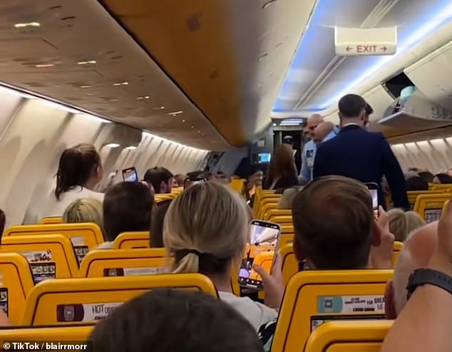 Video footage shared to TikTok showed a woman being led off the grounded plane by several members of staff as countless others filmed the incident