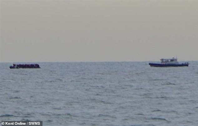 A dinghy carrying migrants (left) is closely followed by another vessel in the Channel, clashing with the Dunkirk commemorative flotilla