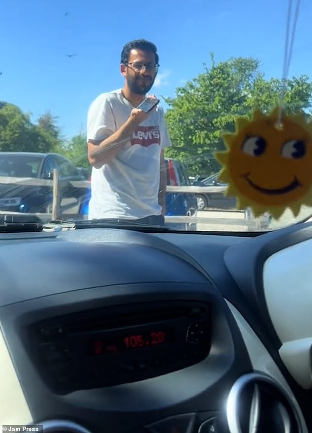 This is the astonishing moment a pedestrian refused to move in a three-minute car park standoff with a driver as he tried to reserve a parking space for his family