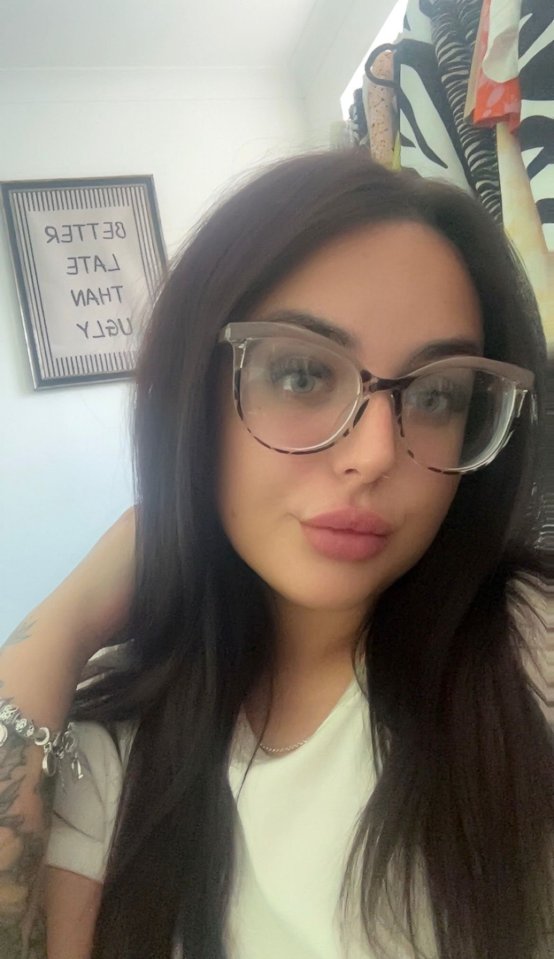 Woman with dark hair and glasses.