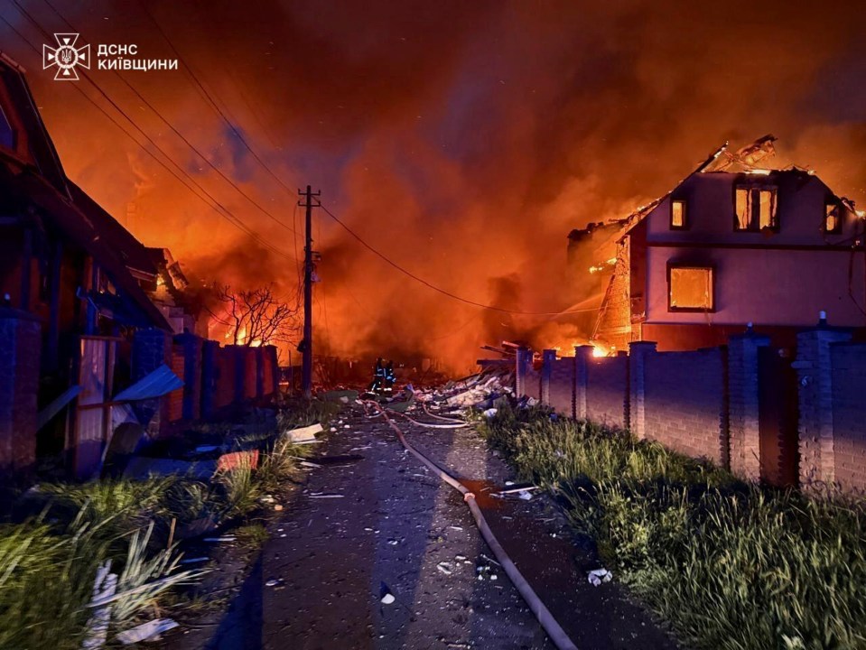 Firefighters battling a fire in a residential area following a Russian attack.