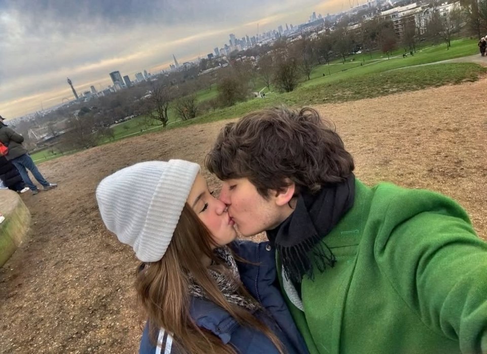 Kings Rossdale and Lola Albert kissing in front of a city skyline.