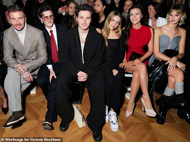 From left to right: David Beckham, Cruz Beckham, Brooklyn Peltz Beckham, Harper Beckham, Nicola Peltz Beckham and Mia Regan attend the Victoria Beckham AW24 show during Paris Fashion Week in 2024