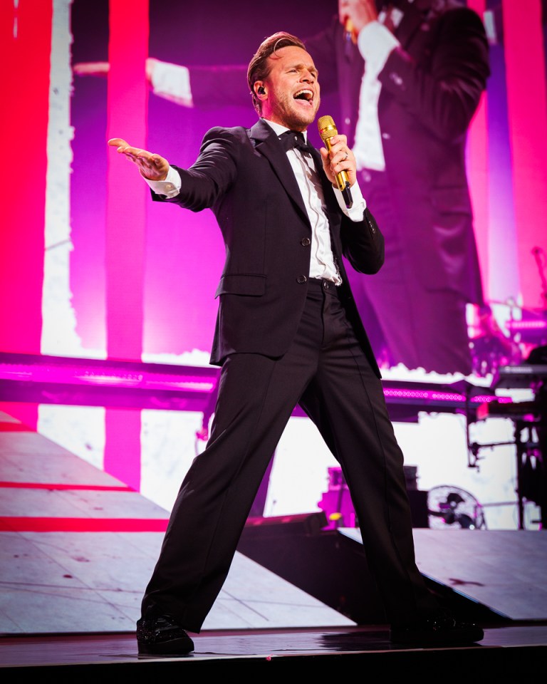Olly Murs performing on stage.