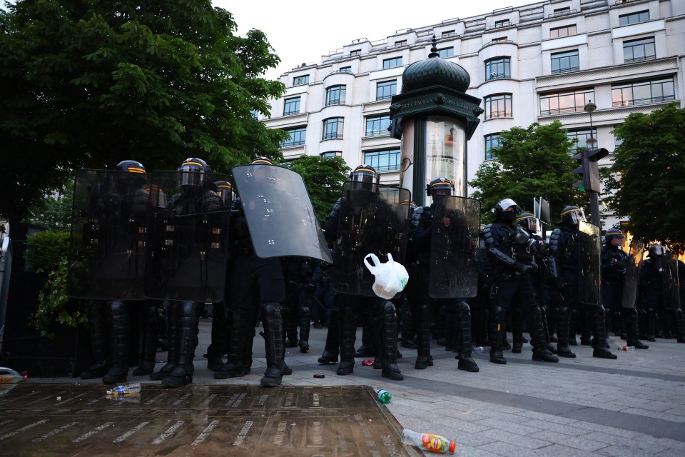 Police officers in riot gear on the Champs-Élysées.