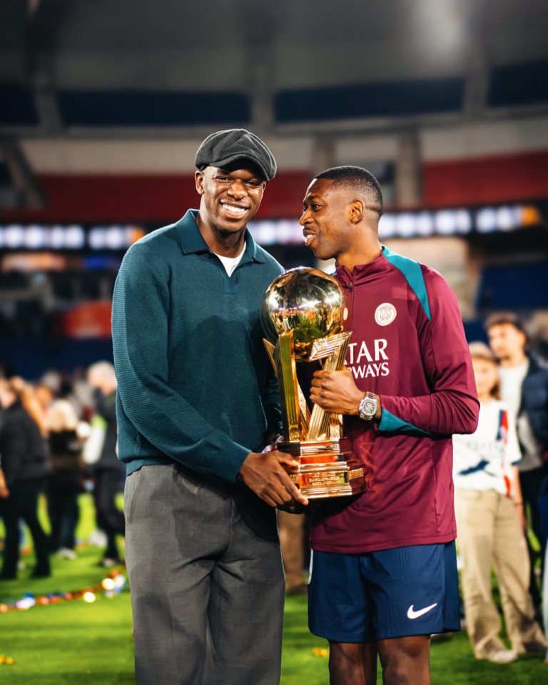 Ousmane Dembele and Moustapha Diatta holding a trophy.