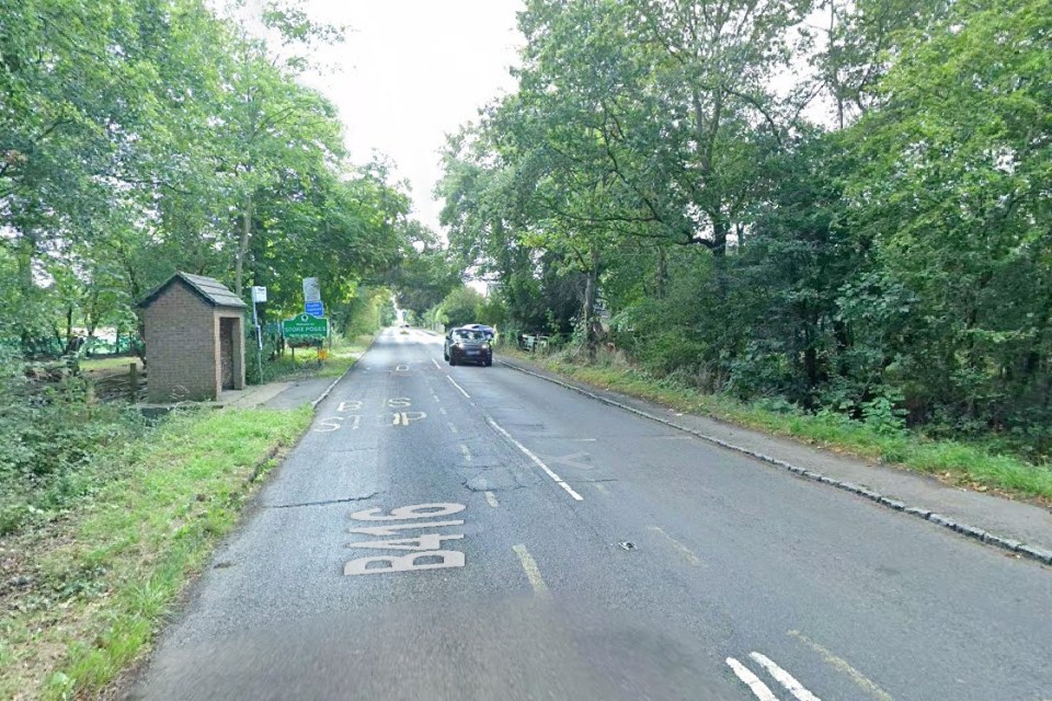 Road scene with bus stop and car.