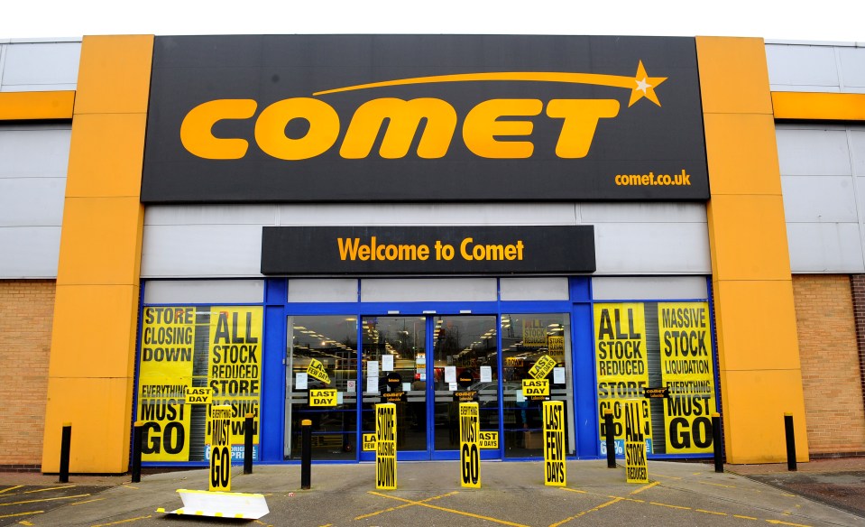 Reflection of a closed Comet electronics store in a puddle.