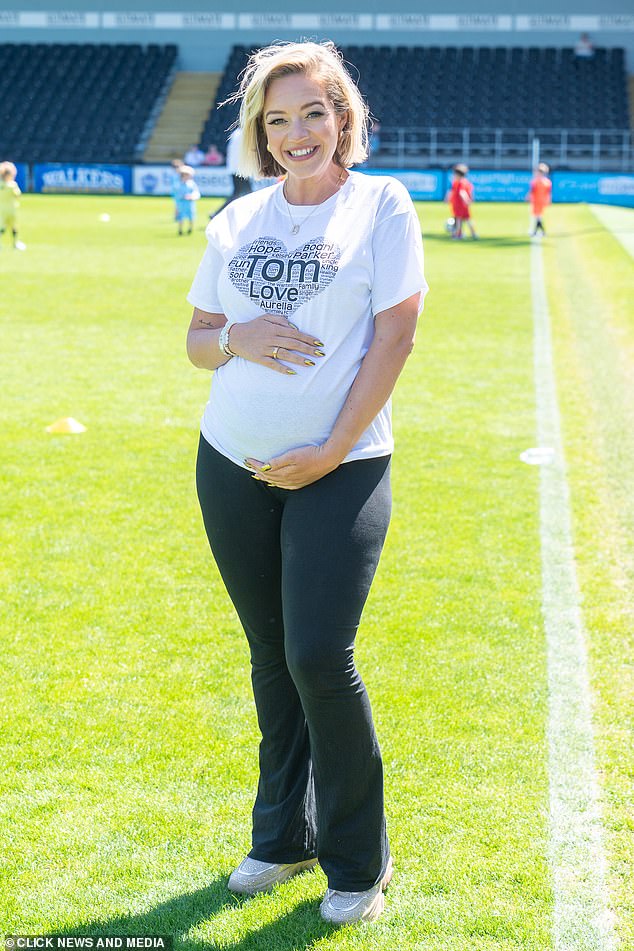 Kelsey Parker showed off her growing baby bump as she led the stars at an annual charity football match in memory of her late husband Tom on Saturday