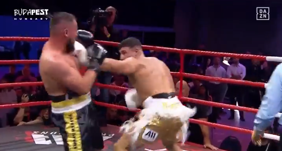 Two boxers fighting in a boxing ring.