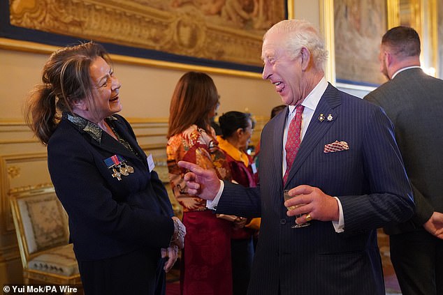 King Charles appeared in good spirits as he spoke to guests at a Windsor Castle reception for members of the Victoria Cross and George Cross Association today