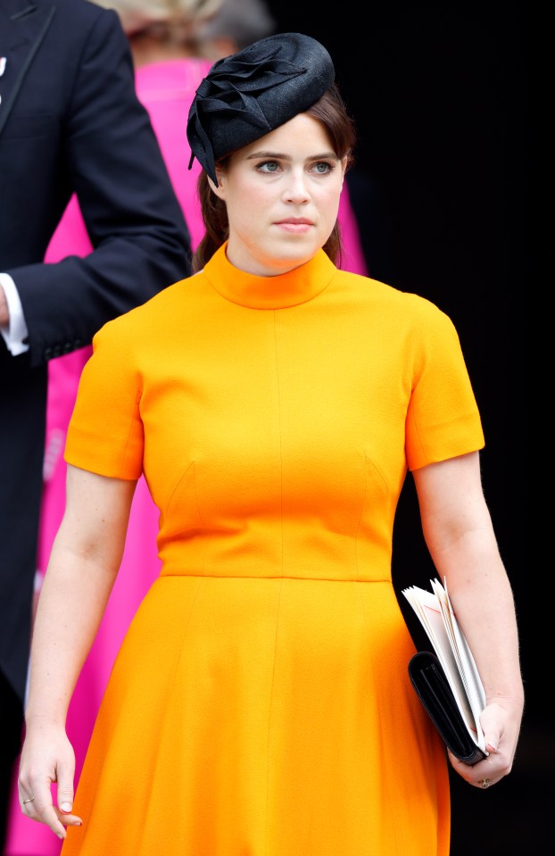 Princess Eugenie at a Platinum Jubilee service in an orange dress and black hat.