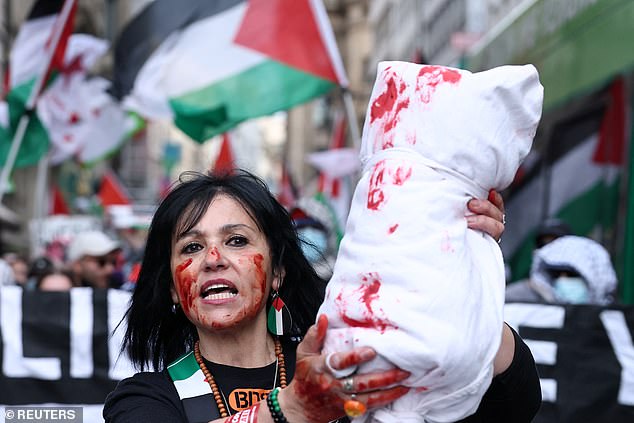 A woman holds a prop, representing a body bag, as pro-Palestinian demonstrators attend a protest, on the day of the Grand Final of the 2025 Eurovision Song Contest in Basel