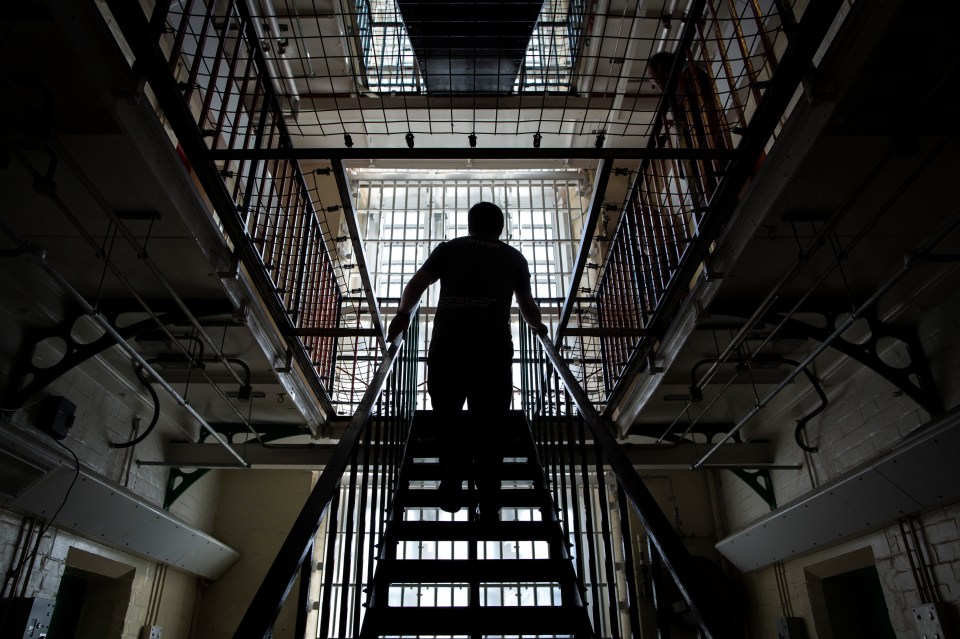 Person ascending a staircase inside Reading Prison.