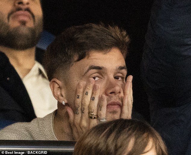 Romeo Beckham looked downcast as he watched Arsenal face-off against PSG during the Champions League semi-final on Wednesday