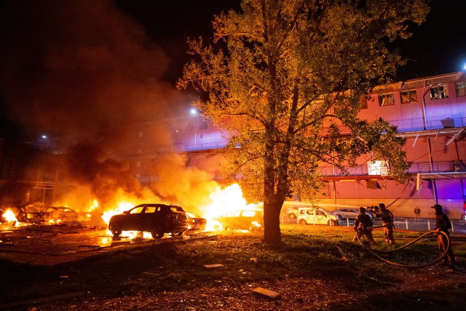 Firefighters battling a fire at the site of a Russian drone strike in Kyiv, Ukraine.