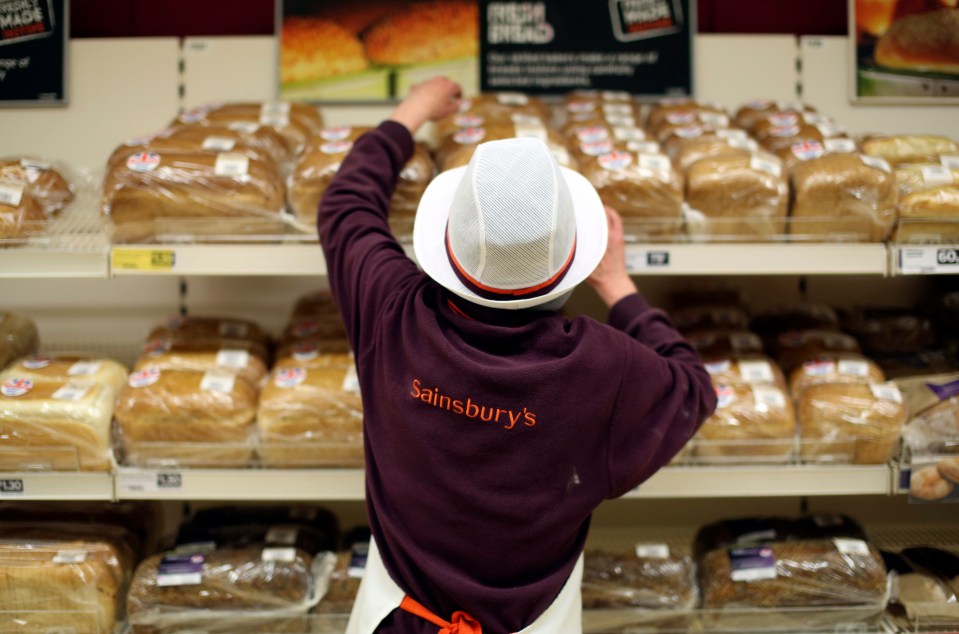 Sainsbury's employee stocking bread.
