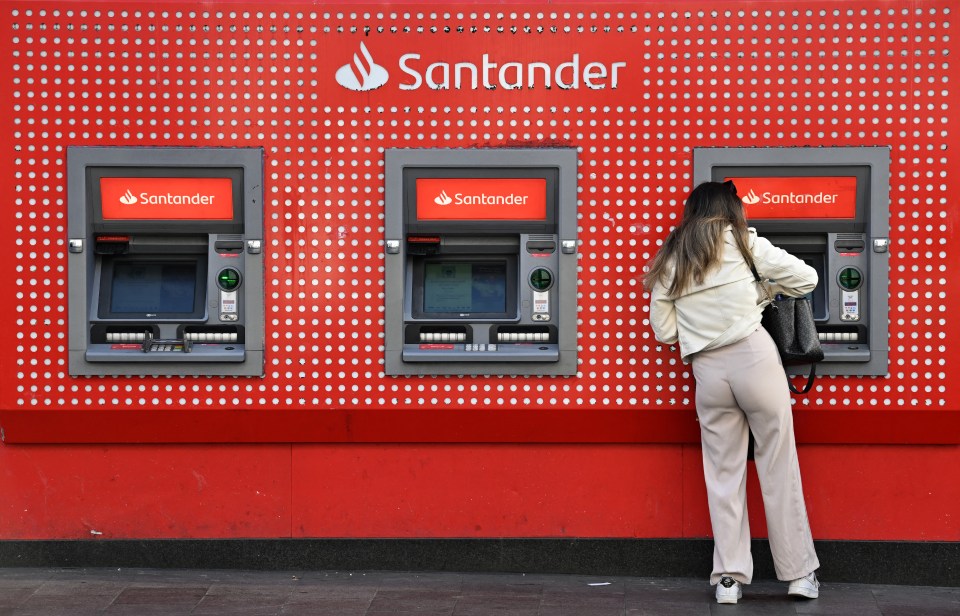 Woman using a Santander ATM.