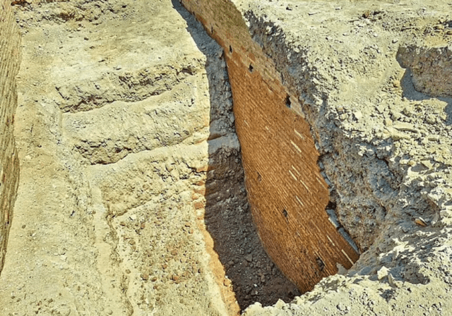 Excavated remains of an ancient brick wall.