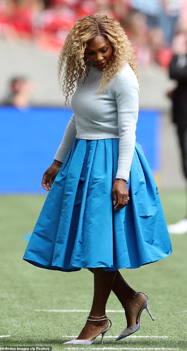 The tennis legend, 43, looked incredible as she stepped out to watch the final against Manchester United in a bright pleated calf-length skirt which she paired with a white woolen jumper