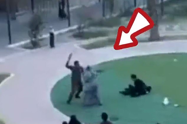A man wielding a belt or leather strap rushes appears to attack women who were protesting