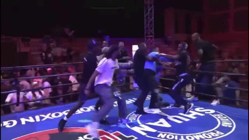 Boxing referee attacked in the ring by several men.