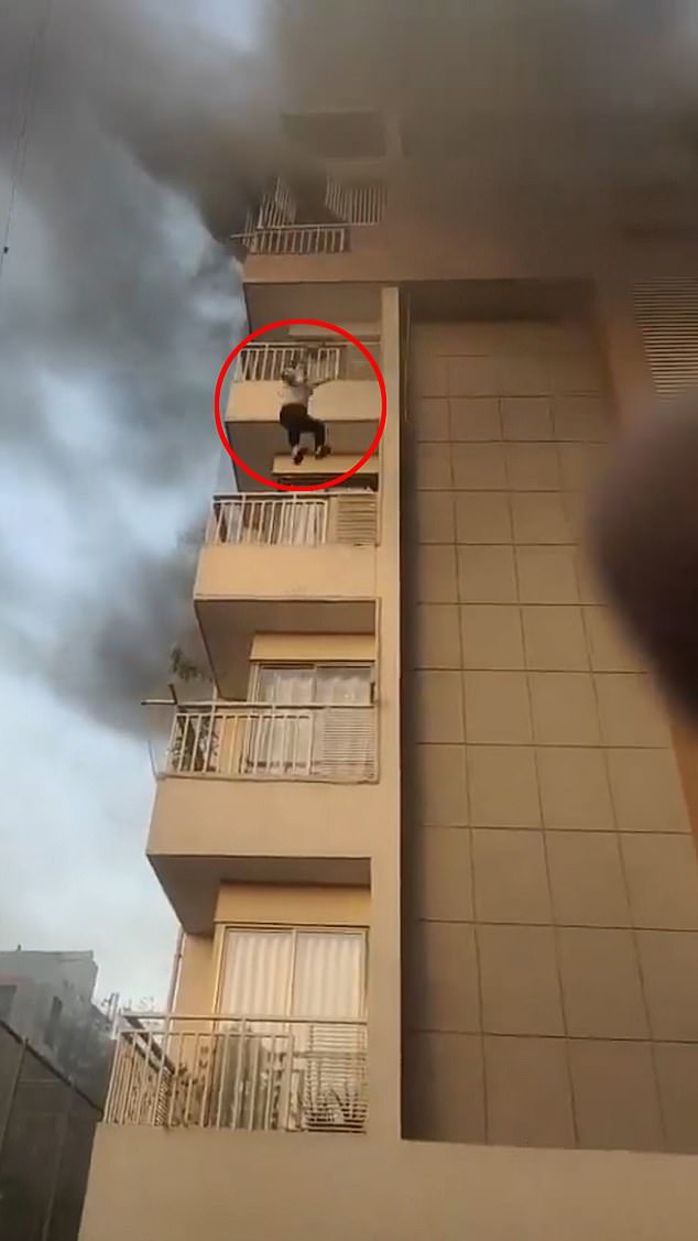 This is the heart-stopping moment a person jumps from the fifth floor of a burning apartment block to escape the flames