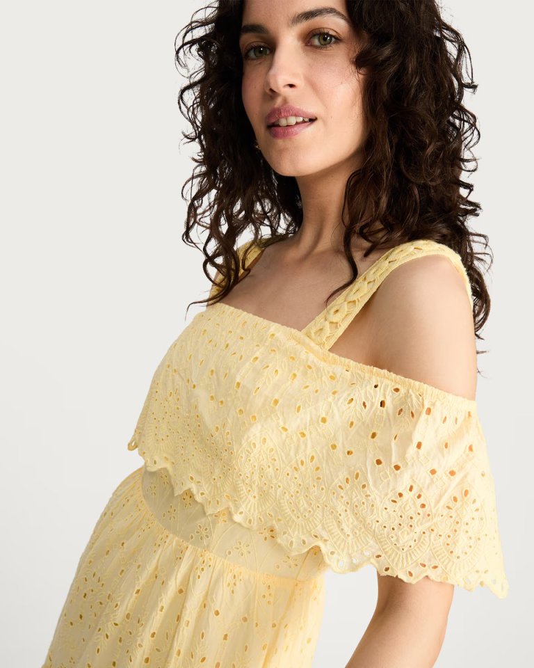 Yellow eyelet midi dress with off-the-shoulder neckline.