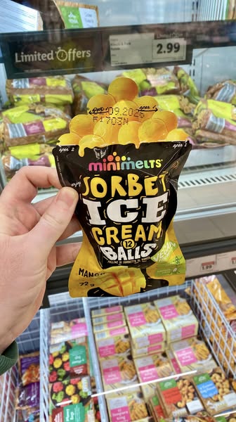 Hand holding a bag of mini melts sorbet ice cream balls.