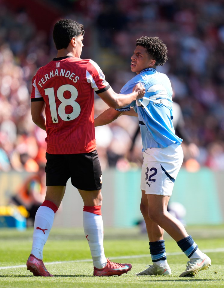 Southampton's Mateus Fernandes and Manchester City's Rico Lewis arguing during a soccer match.