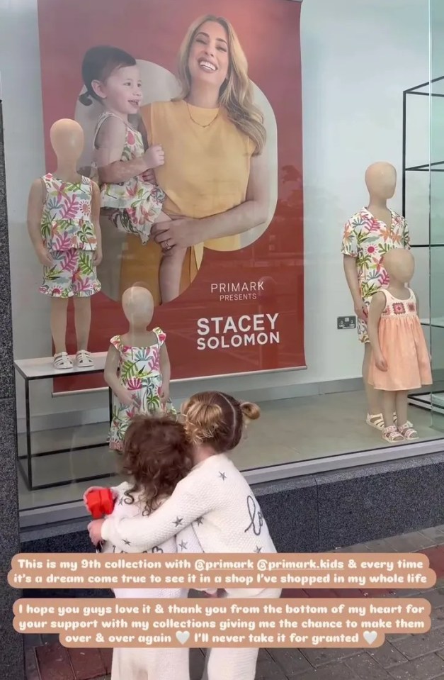 Primark storefront display featuring Stacey Solomon's children's clothing line, with two young girls looking at it.