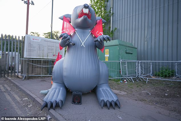 An inflatable rat is seen as bin workers gather on the picket line outside a recycling centre in Birmingham