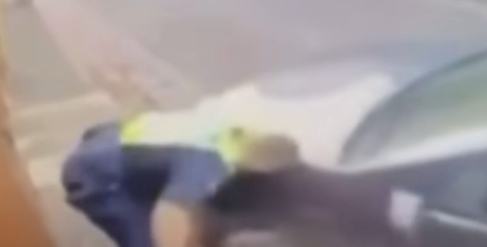 Blurry image of a police officer on the ground.