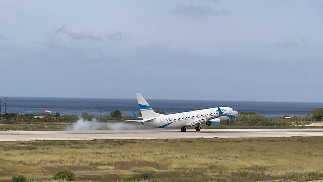 Terrifying footage shows the moment one plane thudded into the runway on Saturday at Rhodes International Airport after gales violently jolted the passenger jet