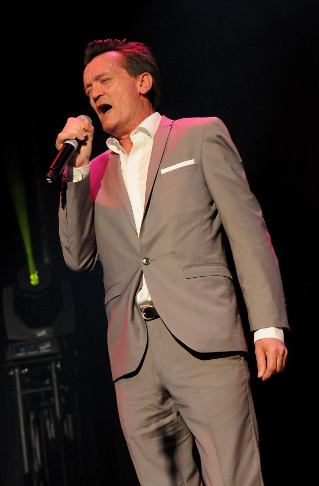 Feargal Sharkey performing on stage.