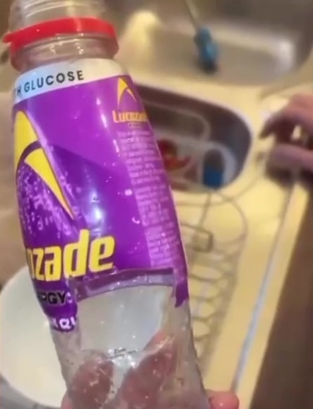 A Lucozade bottle with a hole cut in it.