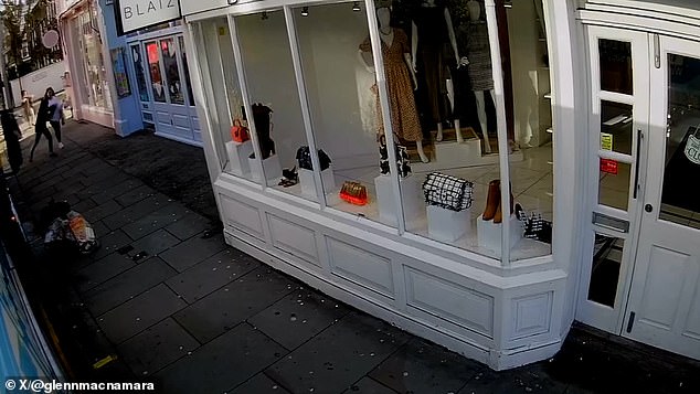 CCTV shows the shocking moment a woman was thrown to the ground as thieves grabbed her mobile phone from her in King's Road, London