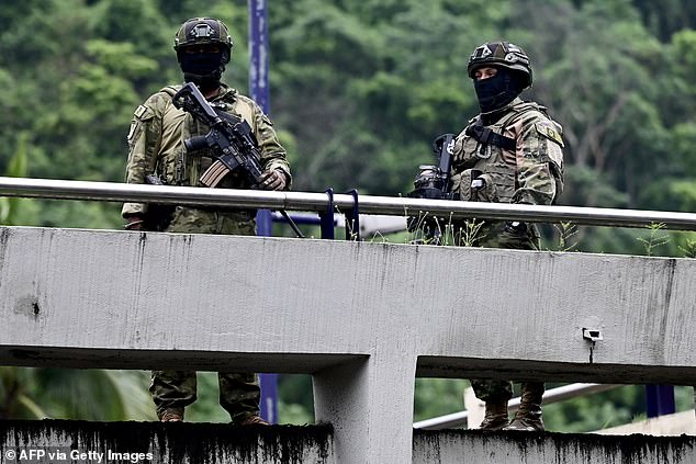 Security forces stand guard at a polling station during the presidential runoff election in Guayaquil, Guayas province, Ecuador, on April 13, 2025