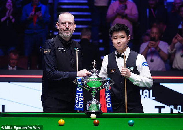 Snooker's newest megastar Zhao Xintong poses with Welsh veteran in front of the world snooker trophy ahead of their final clash at the Crucible in Sheffield