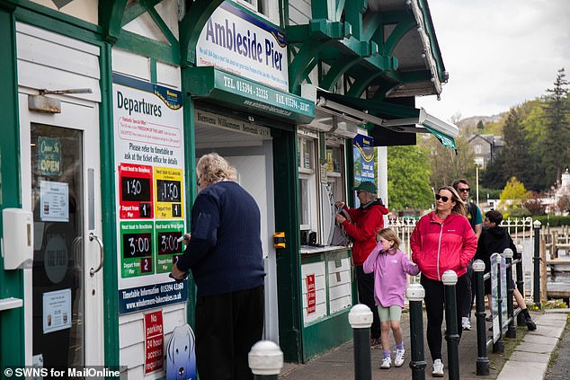 People line up to buy tickets for the Ambleside Pier river tour. While tourism is essential to the Lake District it leaves locals bristling