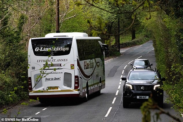 A holidaymakers' coach winds its way through country roads near Ambleside in the Lake District as the summer season begins