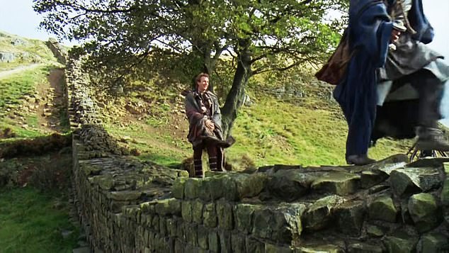 Kevin Costner seen as Robin Hood standing on Hadrian's Wall in front of Sycamore Gap in the 1991 film