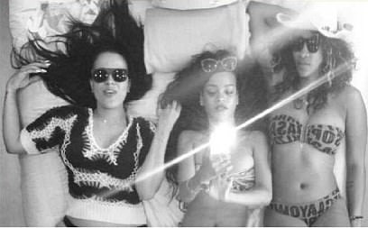 Buried in an evidence file that was submitted to the court is this photo of Rihanna (center), Serena Williams (right) and an unidentified woman believed to be Diddy's former assistant, Capricorn Clark. They are posing beneath a mirrored ceiling on a bed in July 2012