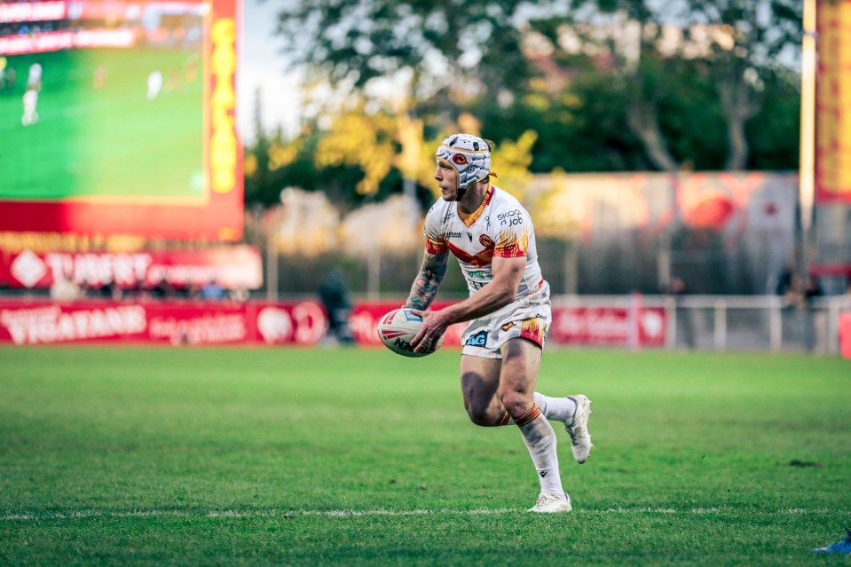 Rugby player running with the ball.