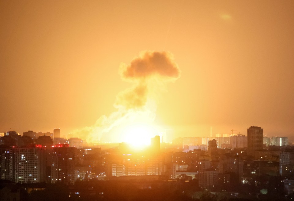 Ballistic missile explosion over a city at night.
