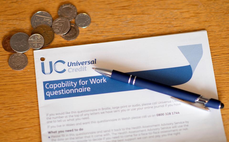 Universal Credit Capability for Work questionnaire with pen and coins.